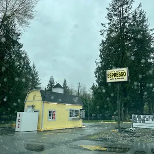 a yellow building with a sign on it