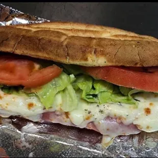a sandwich with tomatoes and lettuce