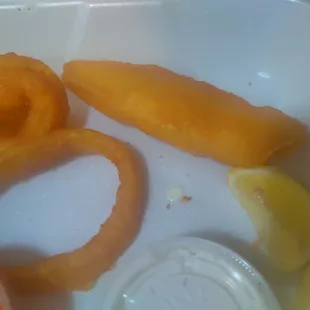 a plate of food with onion rings and ketchup
