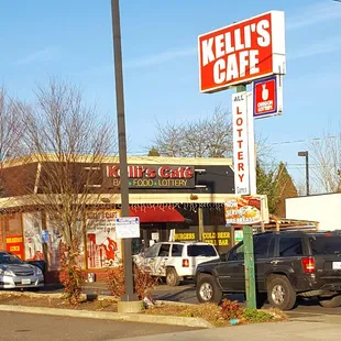 cars parked in front of a kelli's cafe