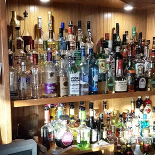 a shelf full of liquor bottles