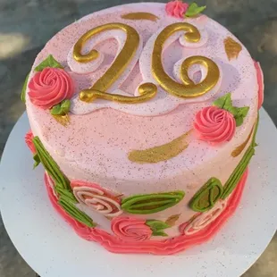 a pink and gold cake