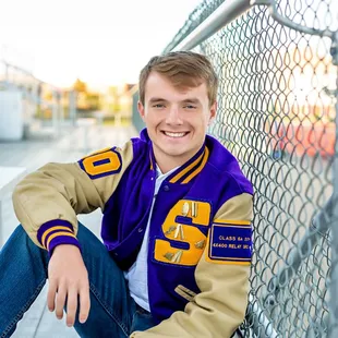 Senior boy, letter jacket at the football field