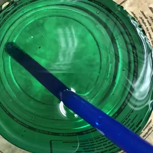 a blue toothbrush in a green cup