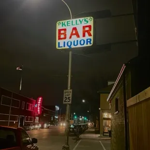 the neon sign for kelly's bar door