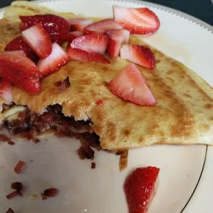 A delicious crepe.... It is a strawberry and bacon and brie cheese