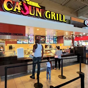a man and a child standing in front of the counter