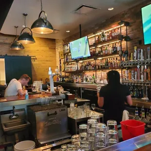 two people working behind the bar