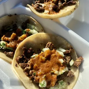 Three carne asada tacos! They&apos;re okay, come as shown with salsa. Cheap. A little too much onion