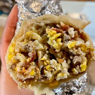 a hand holding a burrito