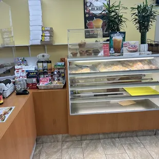 a bakery counter with a variety of baked goods