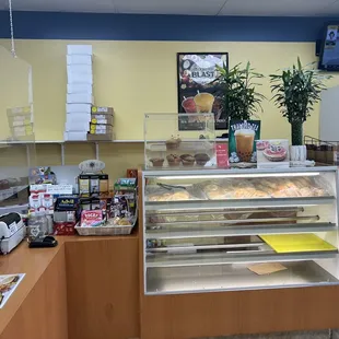 a bakery counter with a variety of pastries