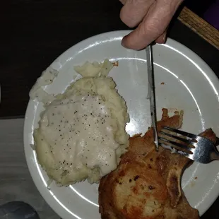 Pork chop dinner, mashed potatoes n&apos; gravy, corn, soup or salad, and dinner roll.  It was so good my mom was gobbling it up before the pic.