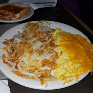 Cheese omelet and a sizeable portion of crispy hashbrowns with toast.