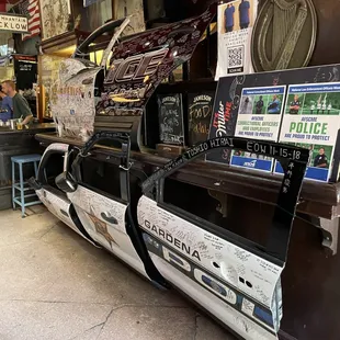 a police car parked in front of a store