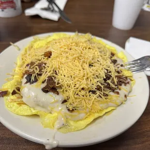 Breakfast Bowl, best thing on the breakfast menu in our opinion A biscuit, Sausage Gravy, Bacon &amp; Cheese all on a bed of Scrambled Eggs!