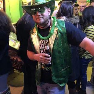 a man in a green hat and green vest