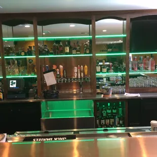 a bar with green lights