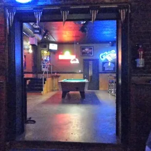a pool table and neon signs