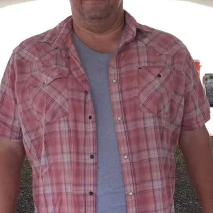 a man standing under a tent