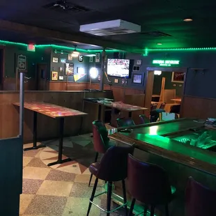 a bar with green lights