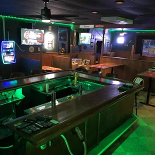 a bar with green lights