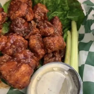 a plate of chicken wings with a side of ranch dressing
