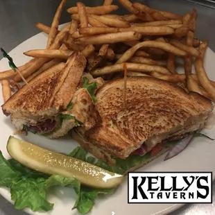 a grilled sandwich and french fries