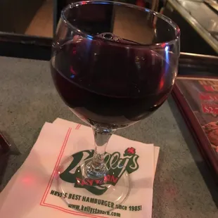 a glass of wine on a napkin