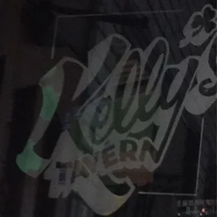 Kelly&apos;s Tavern logo in glass windows