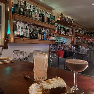 a plate of food and a drink on a bar