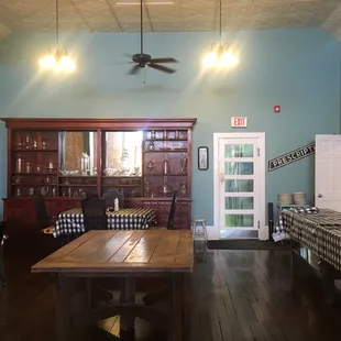 a dining room with blue walls and wood floors