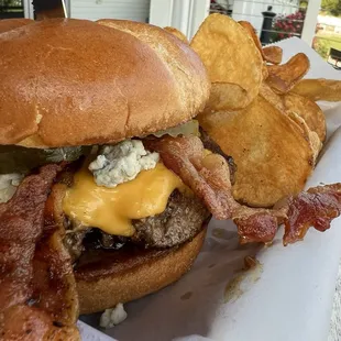 Black and blue burger with homemade chips.