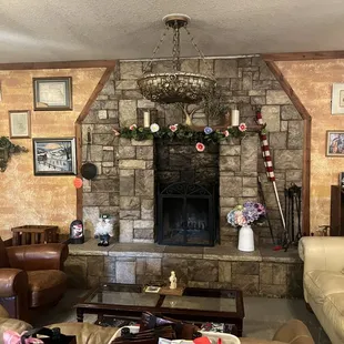 a living room with a stone fireplace