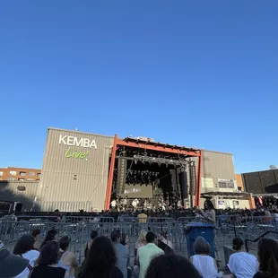 a crowd of people sitting in front of a stage
