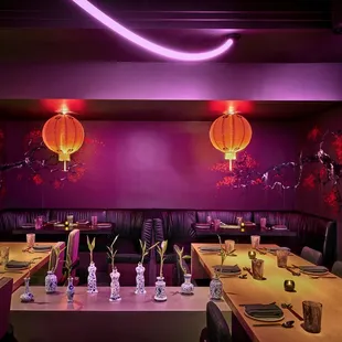 a restaurant with a long table and purple walls