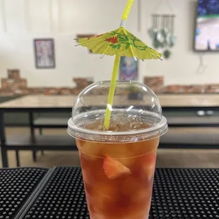a drink with a straw and umbrella