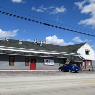 a blue car parked in front of it