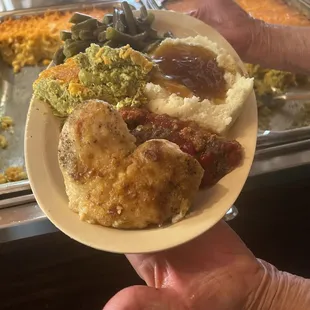 a person holding a plate of food