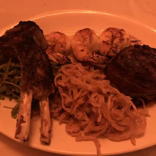 Trio special. Lamb, grilled shrimp and bacon wrapped filet.