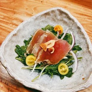 Albacore lightly seared with arugula salad with sweet onions, crispy garlic and ponzu sauce.  First course of Omakase.