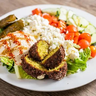 a plate of food with meat, vegetables, and bread