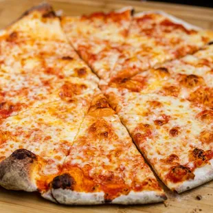 a cheese pizza on a cutting board