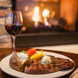 a steak and a glass of wine