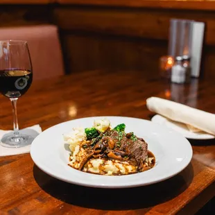 a plate of food and a glass of wine