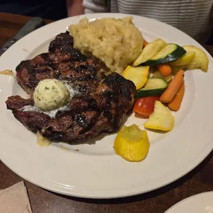 Ribeye steak with mashed potatoes and vegetables
