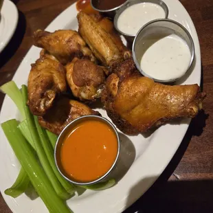 Chicken wings with dry rub and sauces on the side.