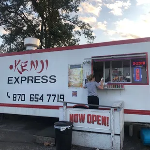 a woman ordering food from a food truck