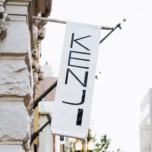 a street sign hanging from the side of a building