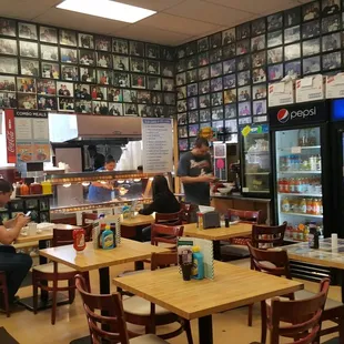 Cute little interior with all sorts of folks framed on the walls.